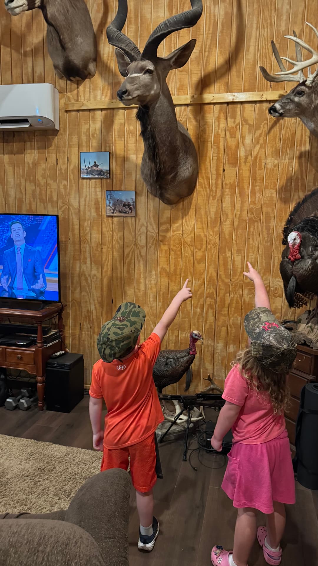 Children looking at the mounts in the lodge trophy room.