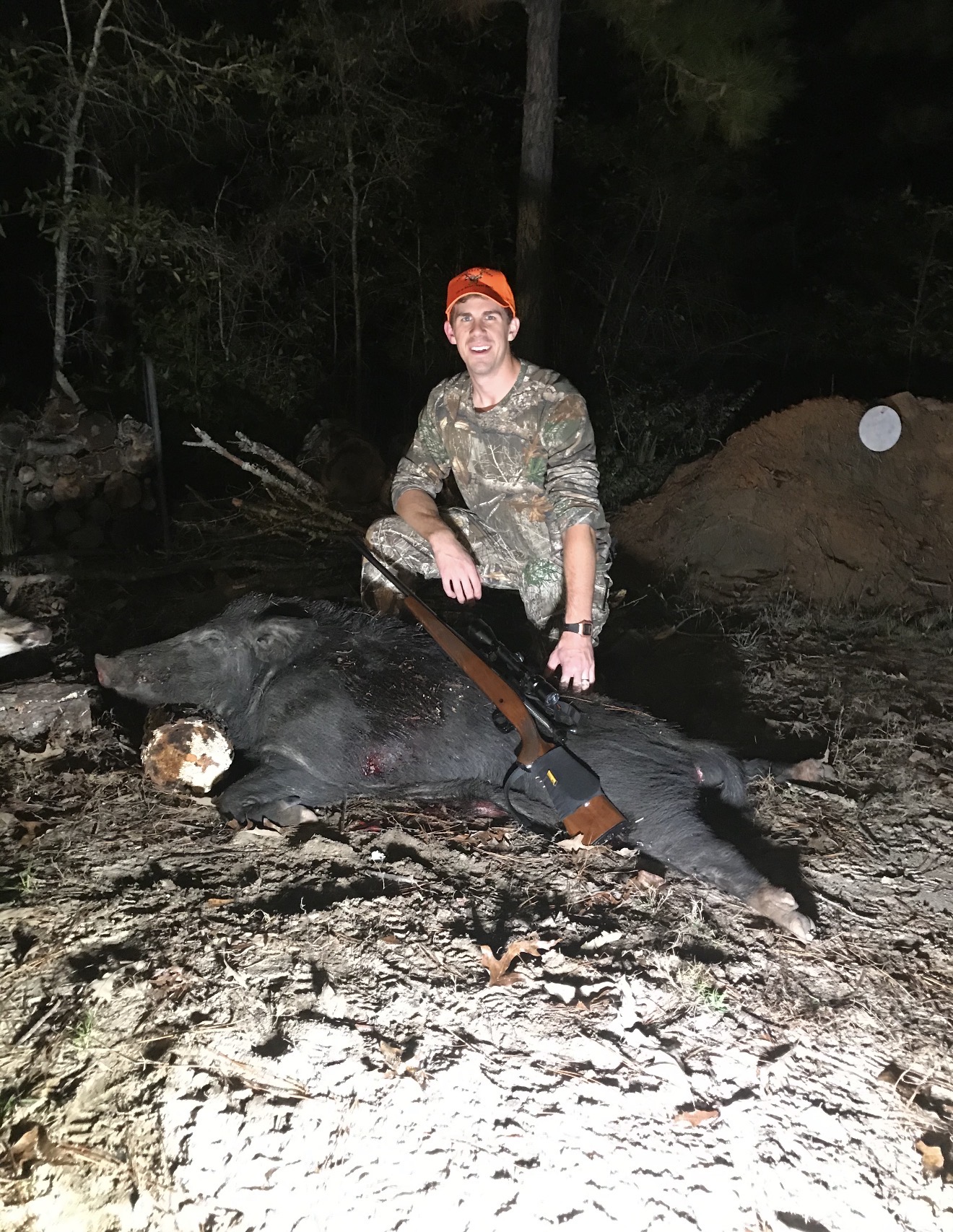 Hunter with a hog recovered after dark.
