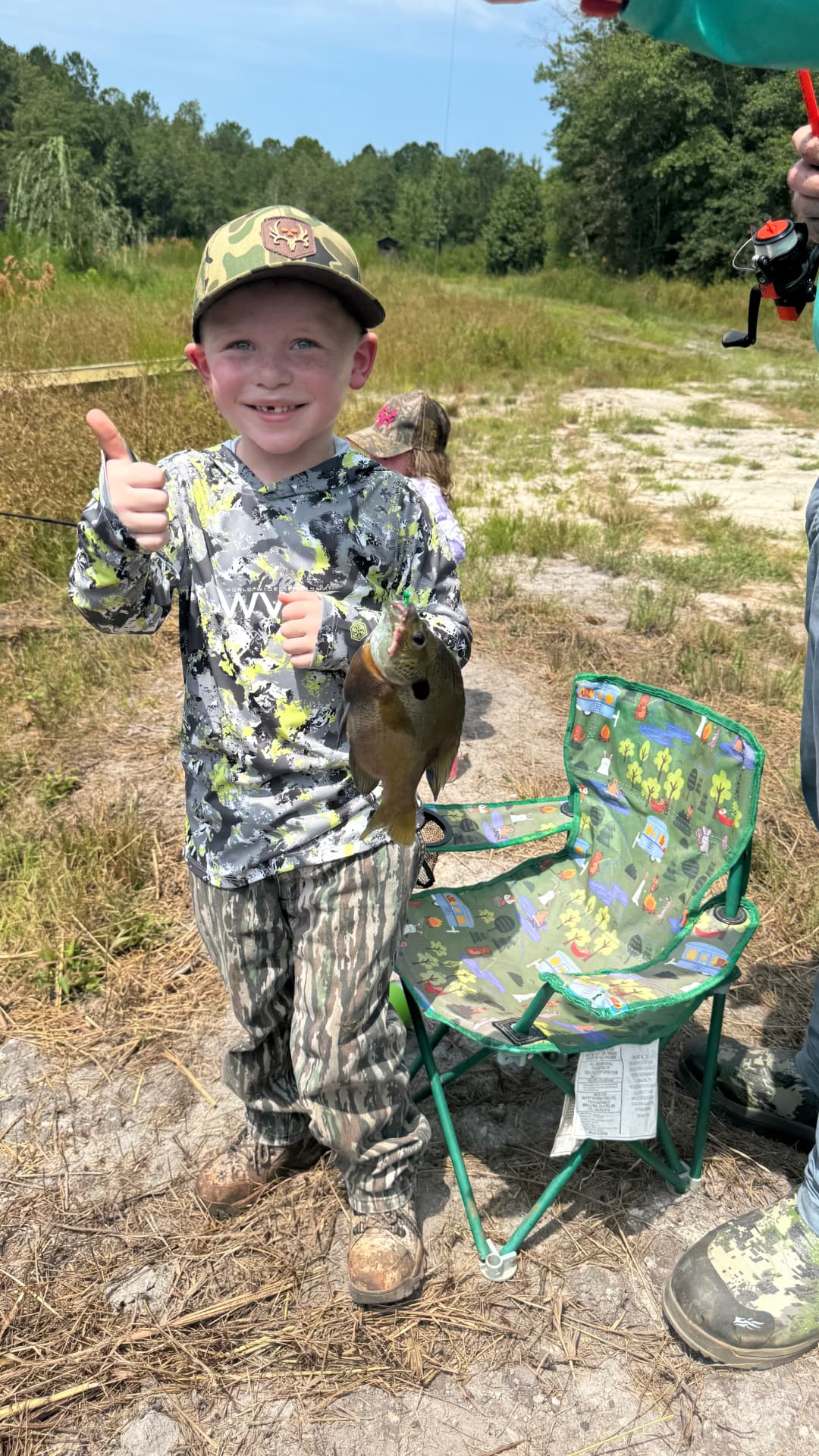 Young angler with a bream from the pond.