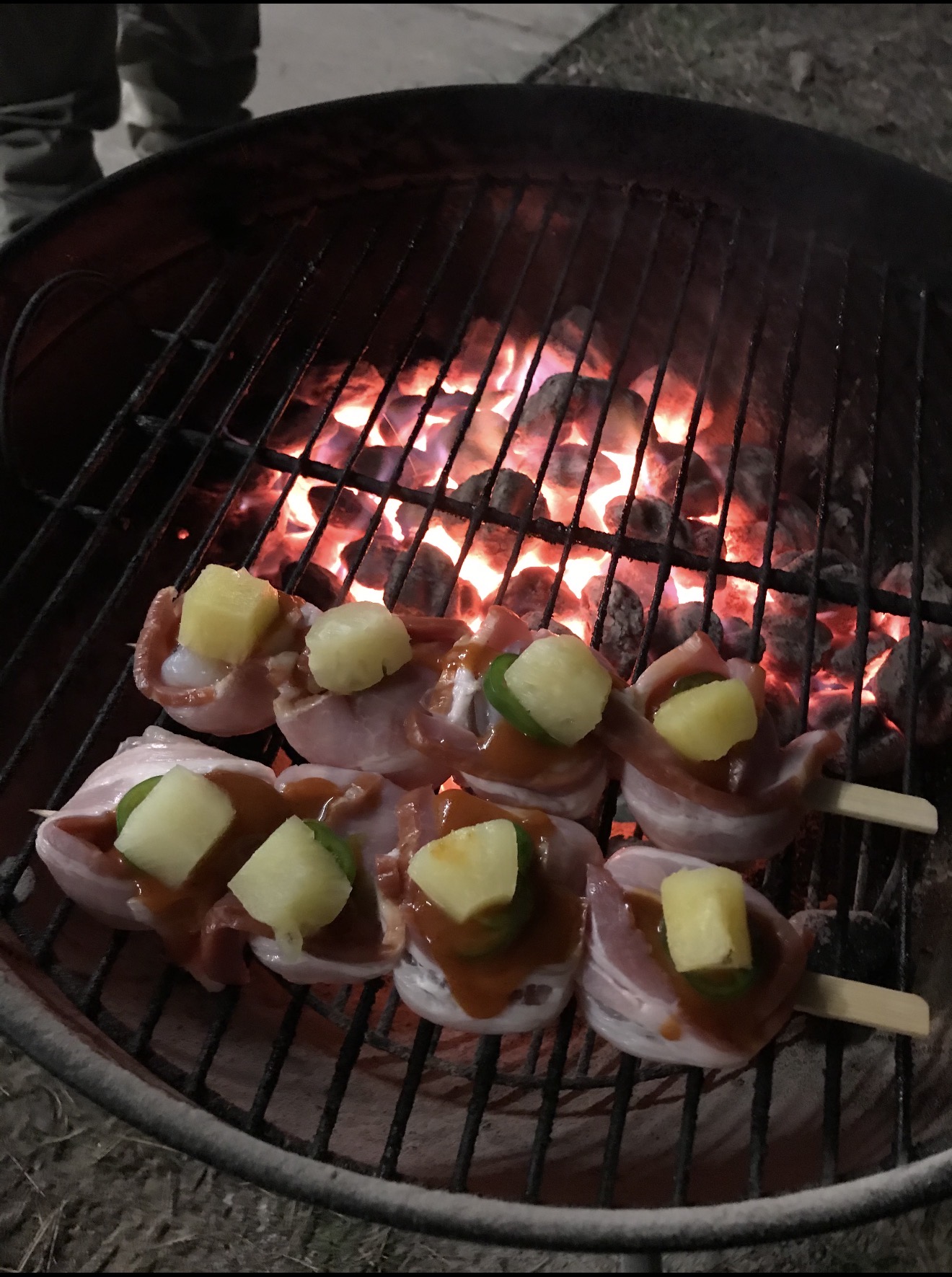 Tony's hog-tied prawn appetizers over charcoal.