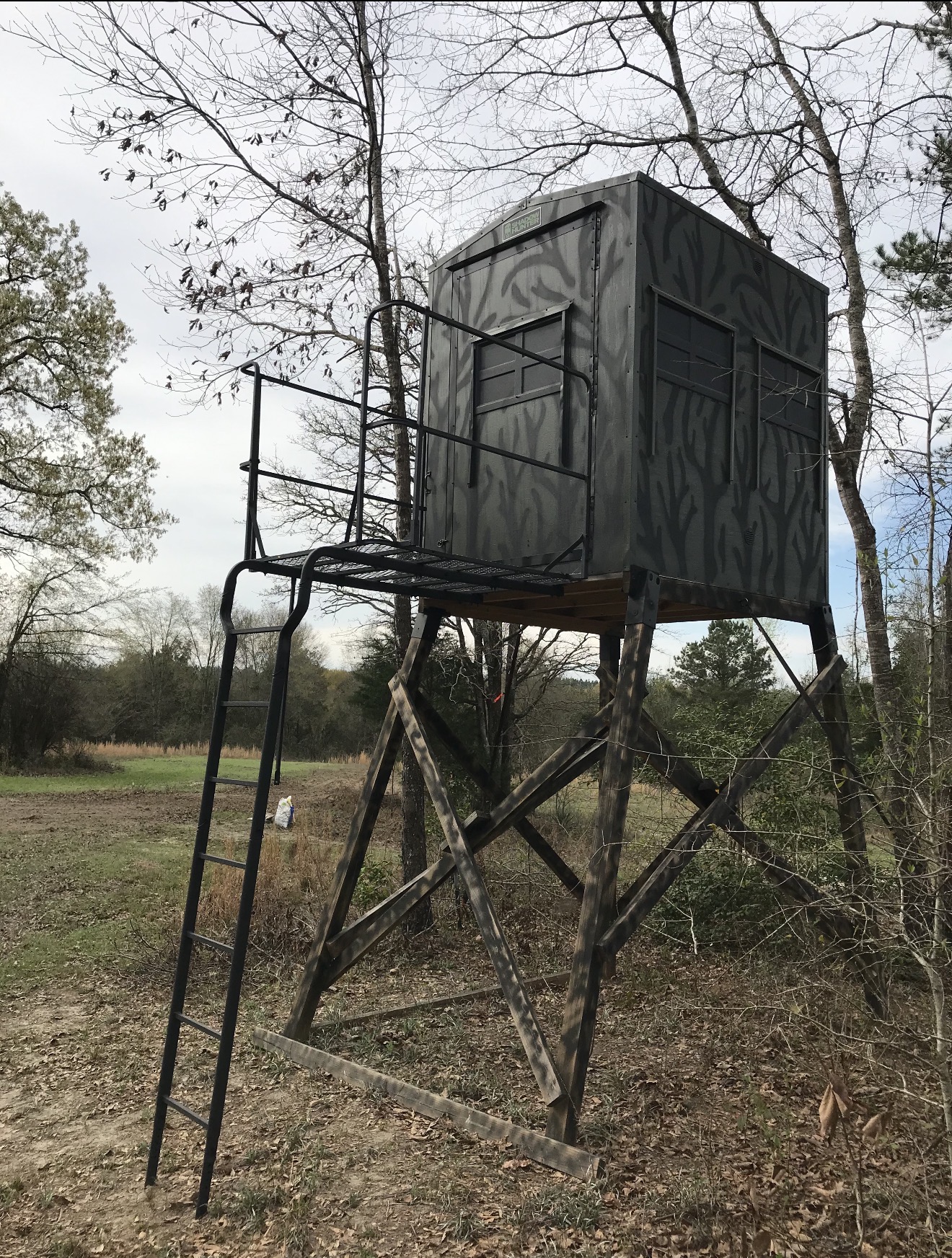 Box blind set up over a field edge.