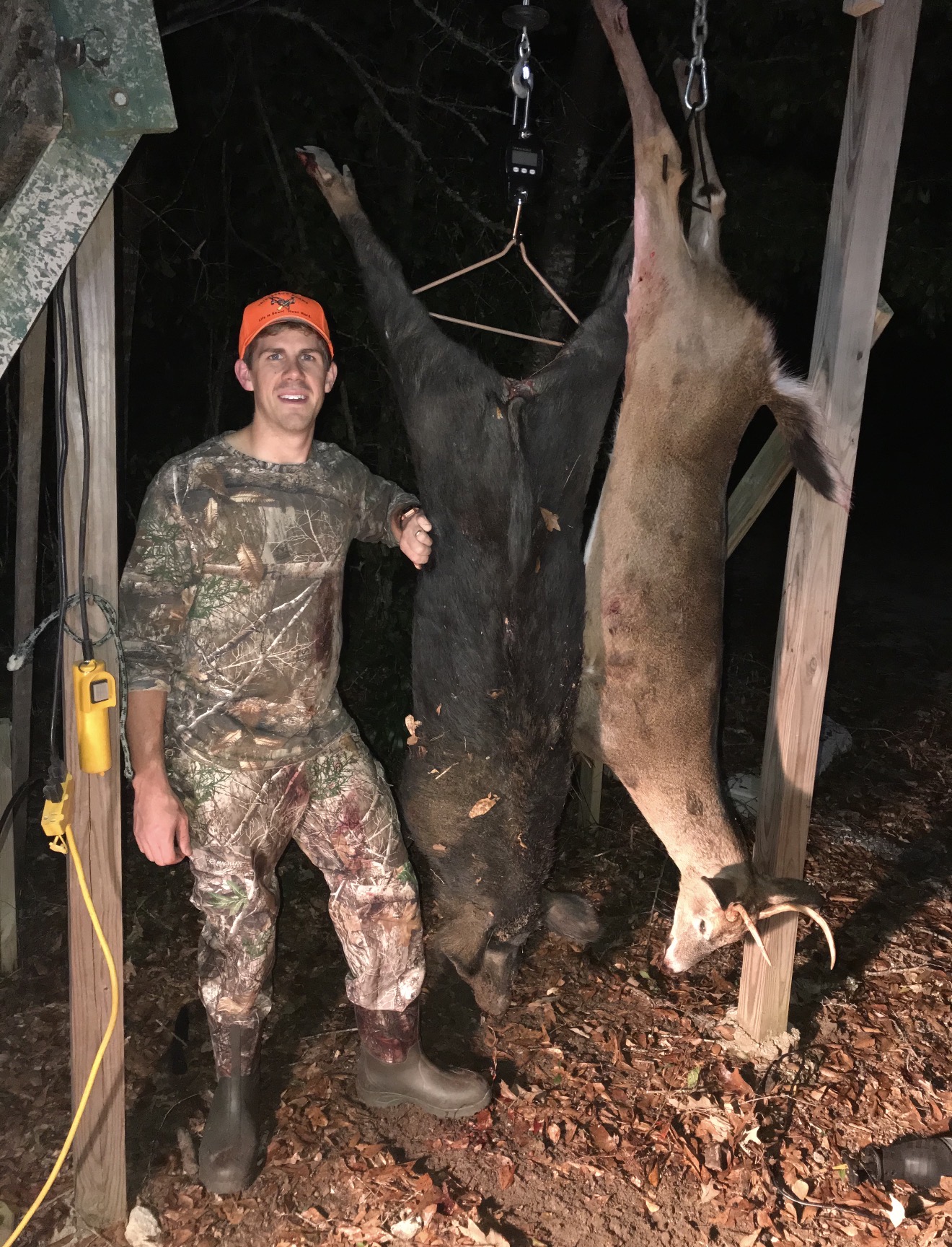 Garrett with his big hog and a management buck in his first visit to Triggerbow.