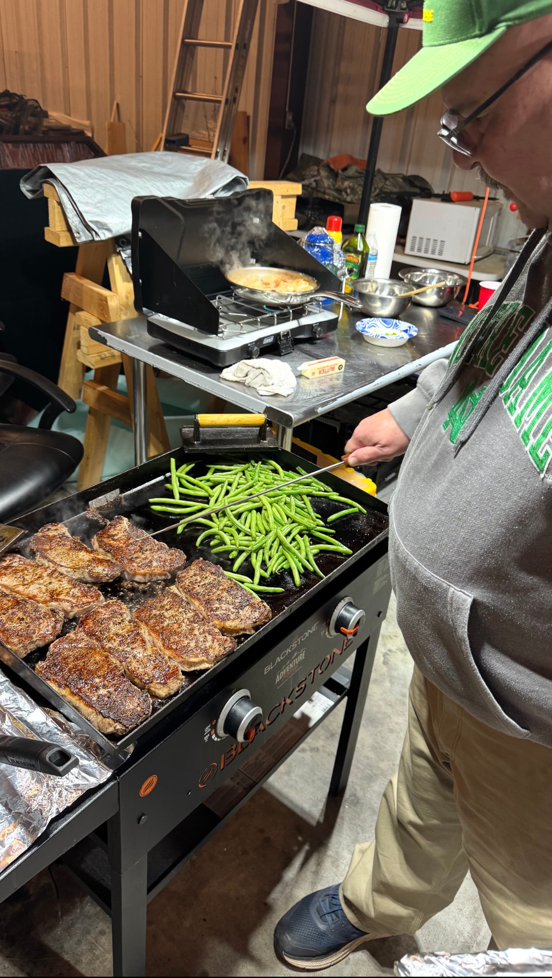 Steaks and green beans on the flat-top griddle.