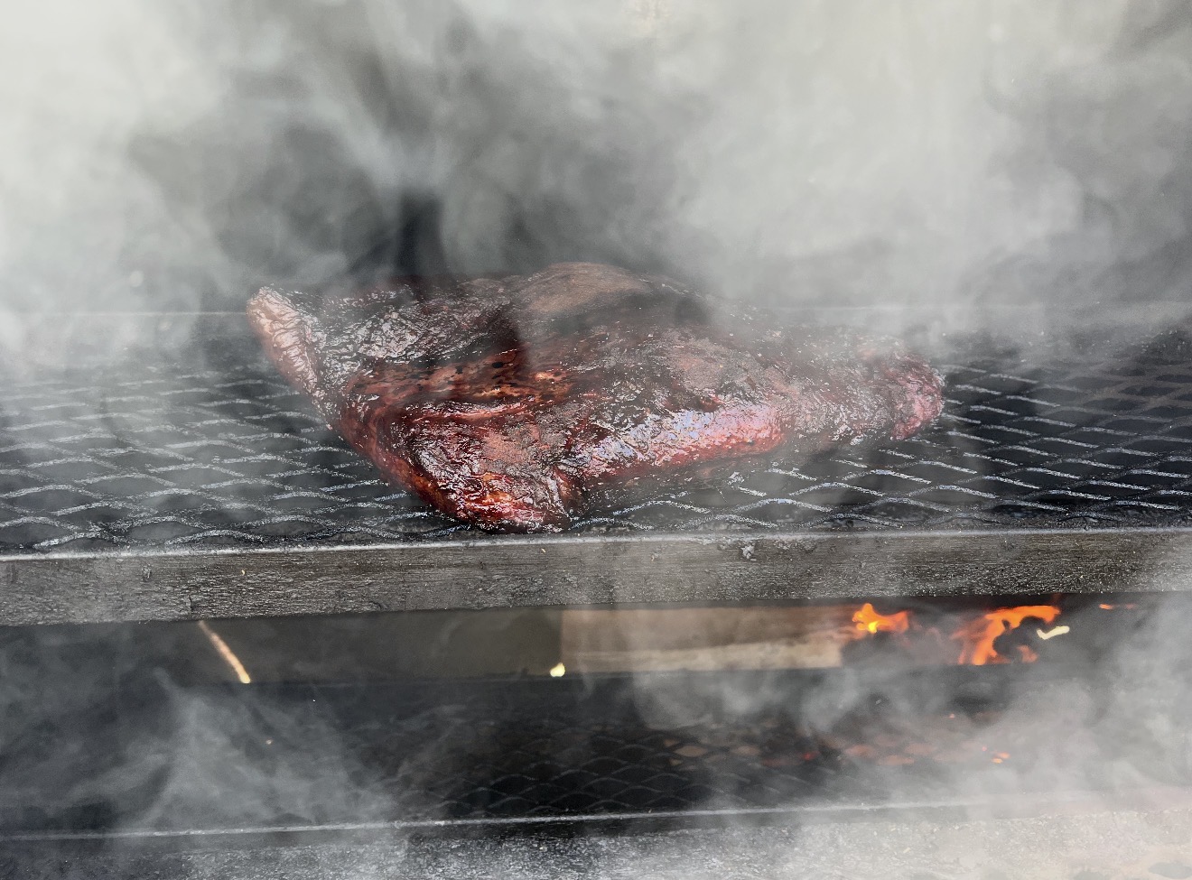 Brisket cooking over live fire.